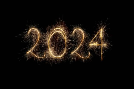 Happy New Year 2024. Number 2024 written sparkling sparklers isolated on black background with copy space for text. Glowing, creative overlay template for holiday greeting card or banner design