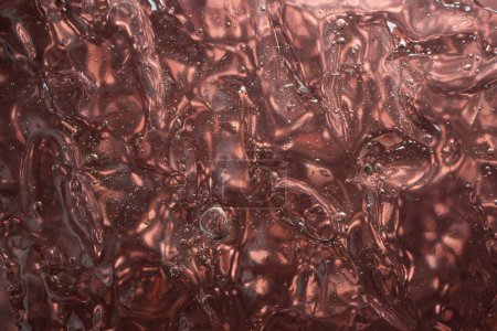 gel structure on metallic brown  background, backdrop for cosmetic products, soft focus  