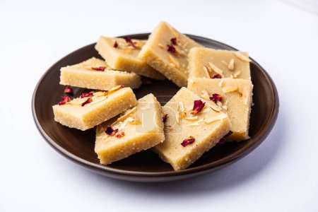 Photo for Rava barfior sooji burfi or barfee is an Indian Sweet made with semolina, sugar, ghee and almonds - Royalty Free Image