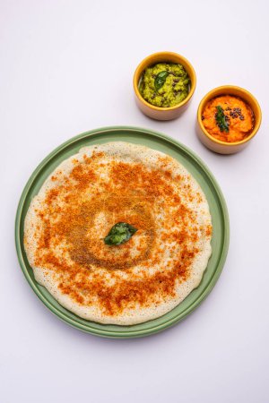 Photo for Podi Dosa or dosai is a south indian spicy and delicious recipe with idli milagai podi or gunpowder - Royalty Free Image