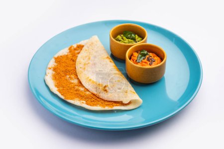 Photo for Podi Dosa or dosai is a south indian spicy and delicious recipe with idli milagai podi or gunpowder - Royalty Free Image