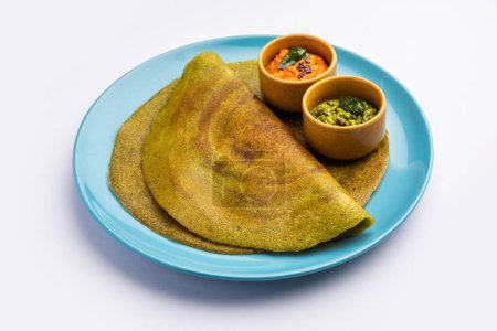 Photo for Pesarattu Dosa or moong dosai is Indian breakfast crepes with green gram served with chutney - Royalty Free Image