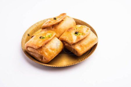 Photo for Lavang Latika: traditional Indian sweet. Crescent shape, deep-fried, soaked in sugar syrup. Served during festivals. - Royalty Free Image