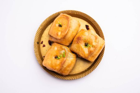 Photo for Lavang Latika: traditional Indian sweet. Crescent shape, deep-fried, soaked in sugar syrup. Served during festivals. - Royalty Free Image