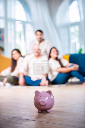 Photo for Financial planning, Indian family mother father and children with piggy Bank at home - Royalty Free Image