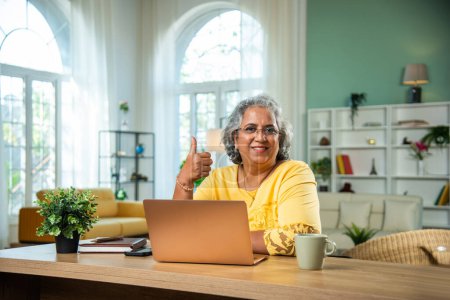 Photo for Indian senior lady using laptop, computer at home office - Royalty Free Image