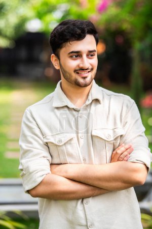 Photo for Handsome Indian young man posing for photograph outdoors - Royalty Free Image