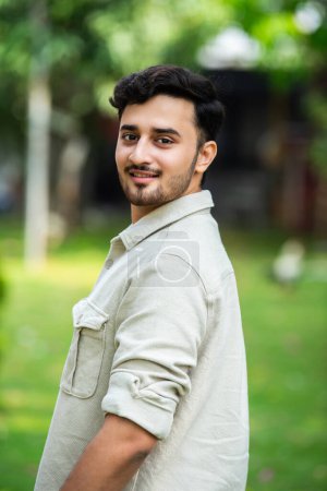 Photo for Handsome Indian young man posing for photograph outdoors - Royalty Free Image