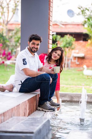 Téléchargez les photos : Indien asiatique jeune couple passer du temps de qualité ayant café en plein air - en image libre de droit