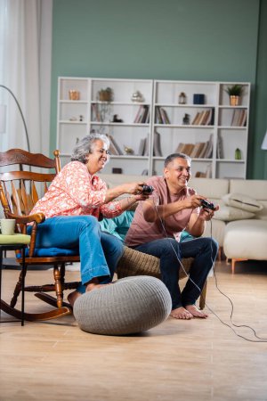 Photo for Mid age Indian couple having fun playing video games - Royalty Free Image