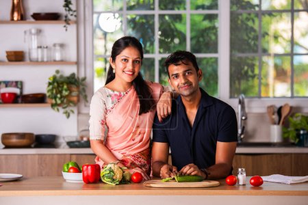 Téléchargez les photos : Indien asiatique jeune couple de travail dans cuisine préparation des repas - en image libre de droit