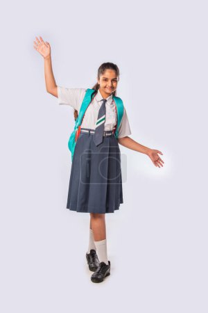 Photo for Indian asian schoolgirl wears school uniform and standing with backpack - Royalty Free Image