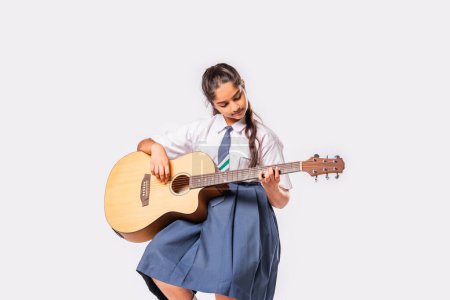 Photo for Asian Indian schoolgirl plays guitar - Royalty Free Image