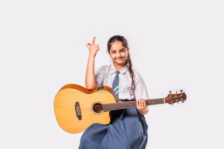Photo for Asian Indian schoolgirl plays guitar - Royalty Free Image