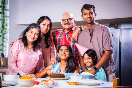 Photo for Indian asian family celebrating a birthday party at home - Royalty Free Image
