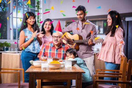 Photo for Indian asian family celebrating a birthday party at home - Royalty Free Image