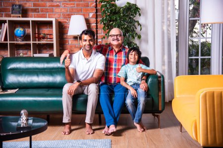 Photo for Indian asian grandpa, father and son sitting on sofa - Royalty Free Image