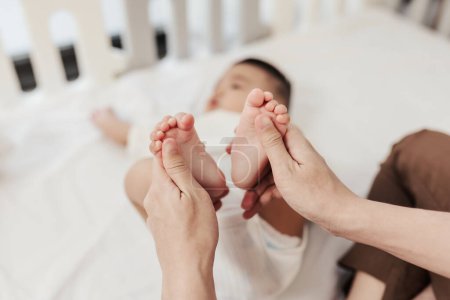 Photo for Selective focus, Baby foot massage for stimulate development by mother. Mother makes massage for happy baby. Infant healthcare concept. - Royalty Free Image