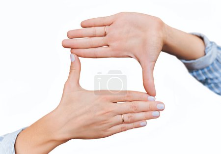 Photo for Female hands are planning a focus in the frame. Focal crop composition in the shot. Concept of Photo school with copy space and mockup on white background. - Royalty Free Image