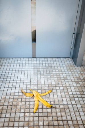 Photo for Peel of banana on a floor. Careful, slippery floor. Risk, failure, danger concept. - Royalty Free Image