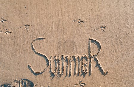 Photo for The word summer is written on the wet sand. The inscription is made by hand. Vacation concept. - Royalty Free Image