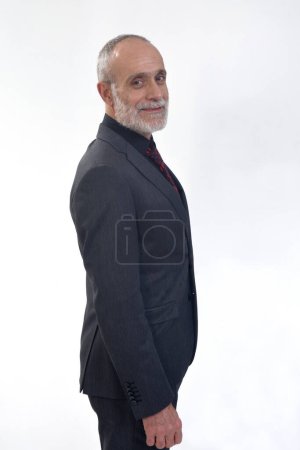 Photo for Portrait of a man who is in profile and looks at the camera on a white background - Royalty Free Image