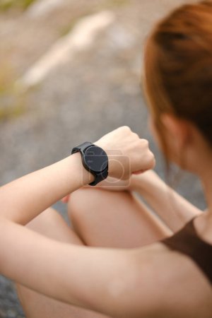 Photo for Burning calories. Cropped closeup of a fit woman looking at her smart watch counting burned calories during her workout at the gym. Woman using fitness bracelet copyspace. High quality photo - Royalty Free Image