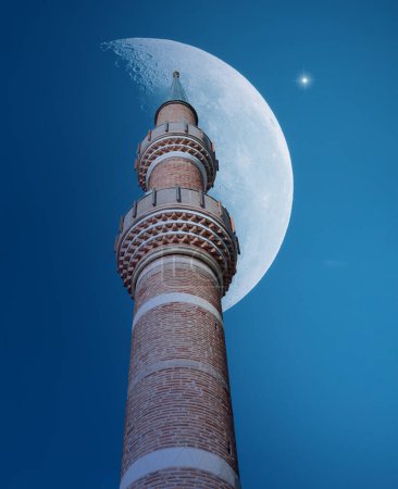 Mosque minaret, shining moon and star in the night sky