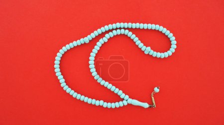 Rosary isolated on red background