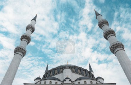 Ramadan, prayer or Islamic concept photo. Bottom-up view of the mosque dome and minarets. 