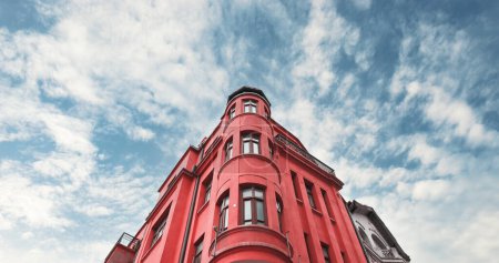 Historical iconic old apartment building in red color.