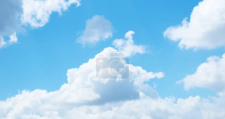 Natural blue sky and cottony fluffy white clouds on sunny day. Beautiful summer day sky background photo.