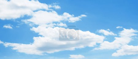 Wide angle  blue sky and cottony fluffy clouds. Panoramic sky background image. Aerial view.