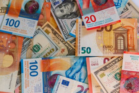 Photo for Multicurrency background of US dollars, euros and Swiss francs - Royalty Free Image