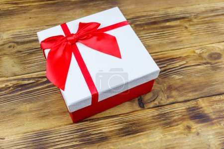 Photo for Gift box on a wooden background - Royalty Free Image