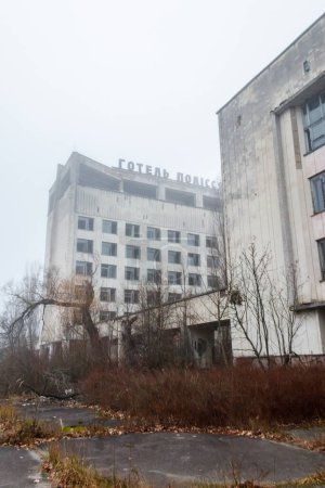 Photo for Abandoned building of Polissya hotel in the ghost town Pripyat in Chernobyl Exclusion Zone, Ukraine. Inscription in Ukrainian: Hotel Polissya - Royalty Free Image