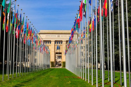 Rows of the United Nations member states flags in a front of Palace of United Nations in Geneva, Switzerland