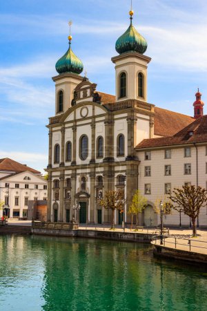 View of Jesuit church and the Reuss river in Lucerne, Switzerland