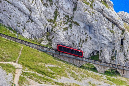 Cogwheel train climbing to the top of Mount Pilatus in Canton Lucerne, Switzerland. World's steepest cogwheel railway