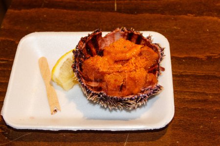 Sea urchin with lemon on wooden table