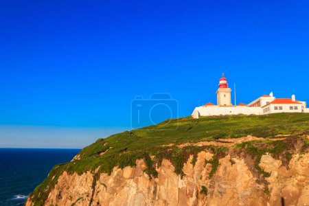 Lighthouse on the cliff at Cabo da Roca. Cabo da Roca or Cape Roca is westernmost cape of mainland Portugal, continental Europe and the Eurasian land mass