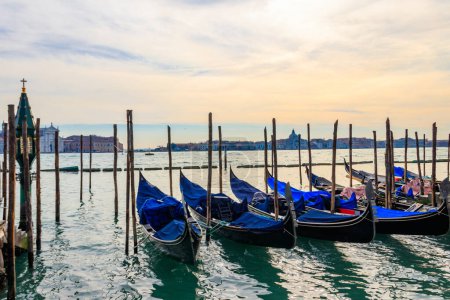 Traditional Gondolas moored on the pier in the Grand Canal in Venice, Italy