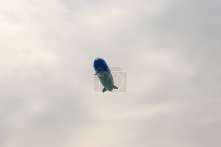 Photo for Blimp, airship or dirigible flying in sky - Royalty Free Image