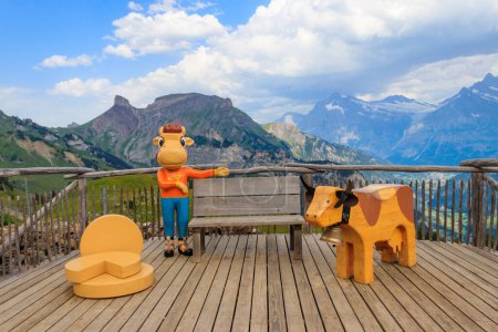 Wooden statues of cows with bench on observation deck at Schynige Platte, Switzerland