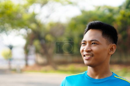 Close up happy young strong sporty athletic toned fit sportsman man in sports clothes warm up train look aside at sunrise sun dawn over park outdoor on pier seaside in summer day morning.