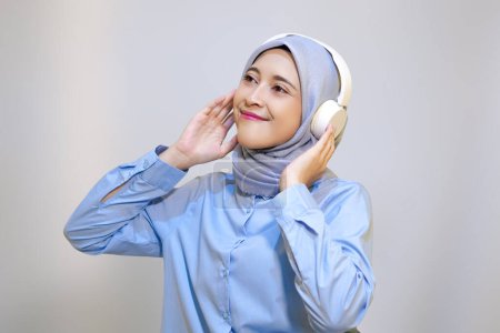 Photo for Cute young muslim woman enjoying music with headphone on. Enjoying music concept - Royalty Free Image