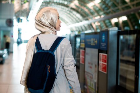 Asian muslim woman on subway train transit system public. Public transport concept