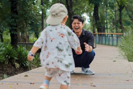 Father and Son Bonding and having a Playful Day Out in the Park. Father and son outdoor play concept