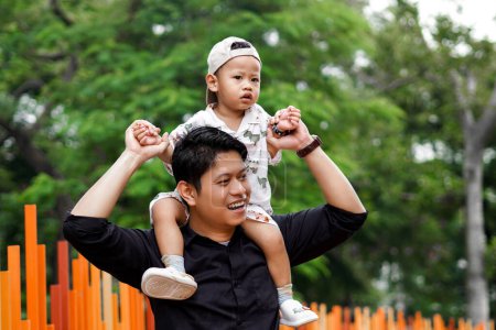 A Father's Love. Playing and Bonding with His Son in the Park, Father Carrying and lifting His Boy.