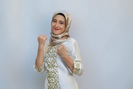 Indonesian muslim Woman Celebrating Success in Ramadan on White Background